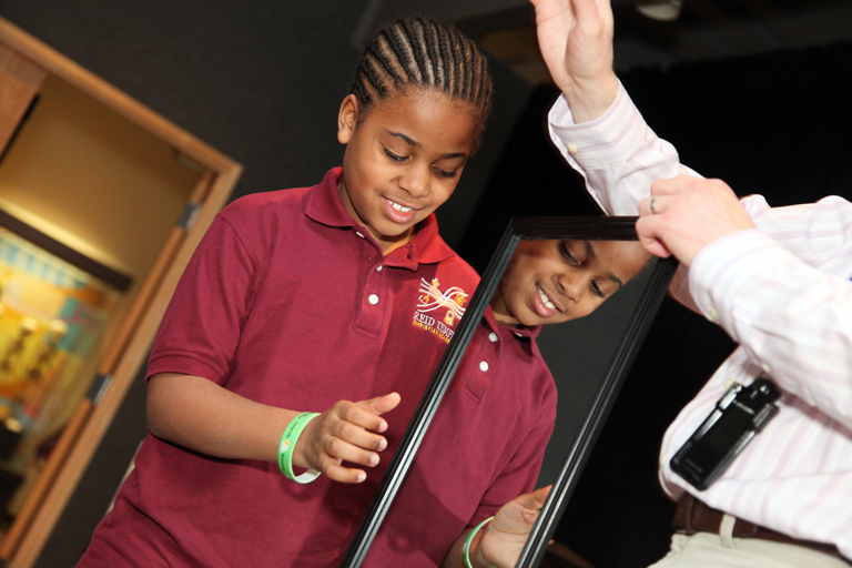 A boy participates in a demonstration about phantom limbs at a 2011 National Museum of Health and Medicine Brain Awareness event in Washington, DC.